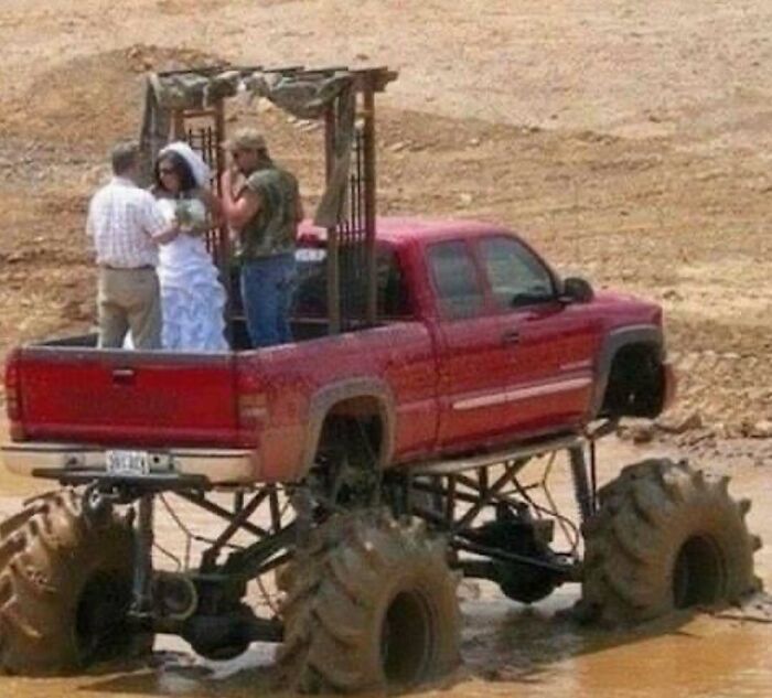 Bride and groom standing inside the bed of a monster truck during an unusual outdoor wedding ceremony, cursed photo example.