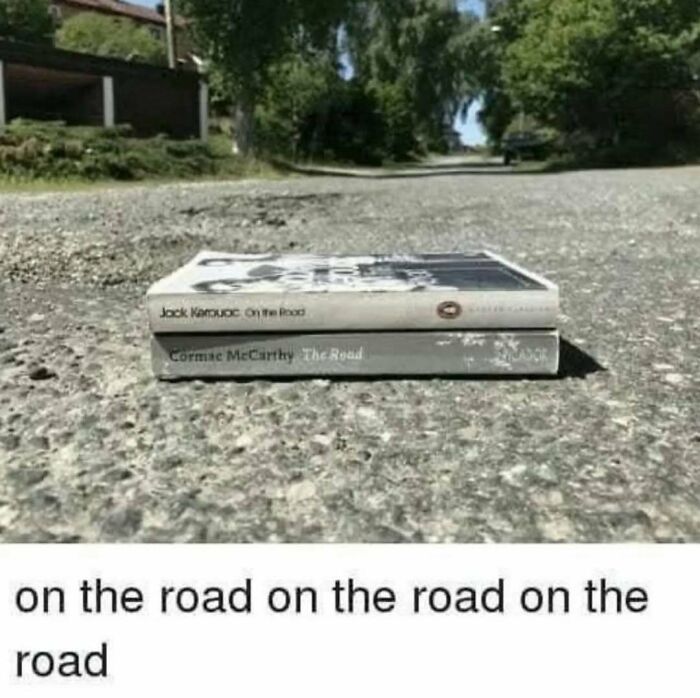 Two books titled On the Road stacked on a road surface, illustrating a visual pun for memes about existential crisis.