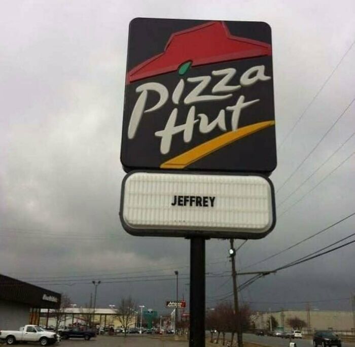 Pizza Hut sign displaying only the name Jeffrey beneath the logo, a cursed photo that makes zero sense.