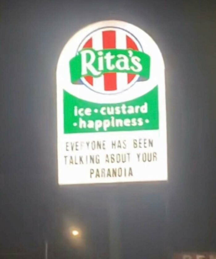 Illuminated Rita's sign at night with a strange message mentioning paranoia, fitting cursed photos that make zero sense.