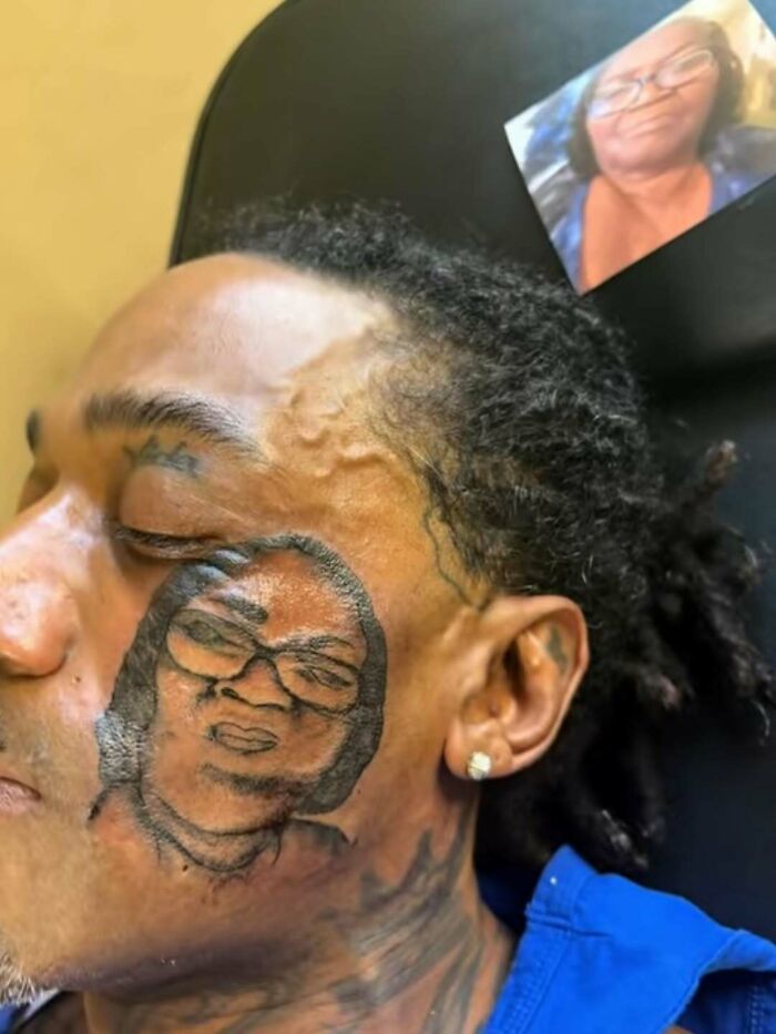 Man with a cursed photo tattoo on his face depicting a distorted portrait from a printed image nearby.