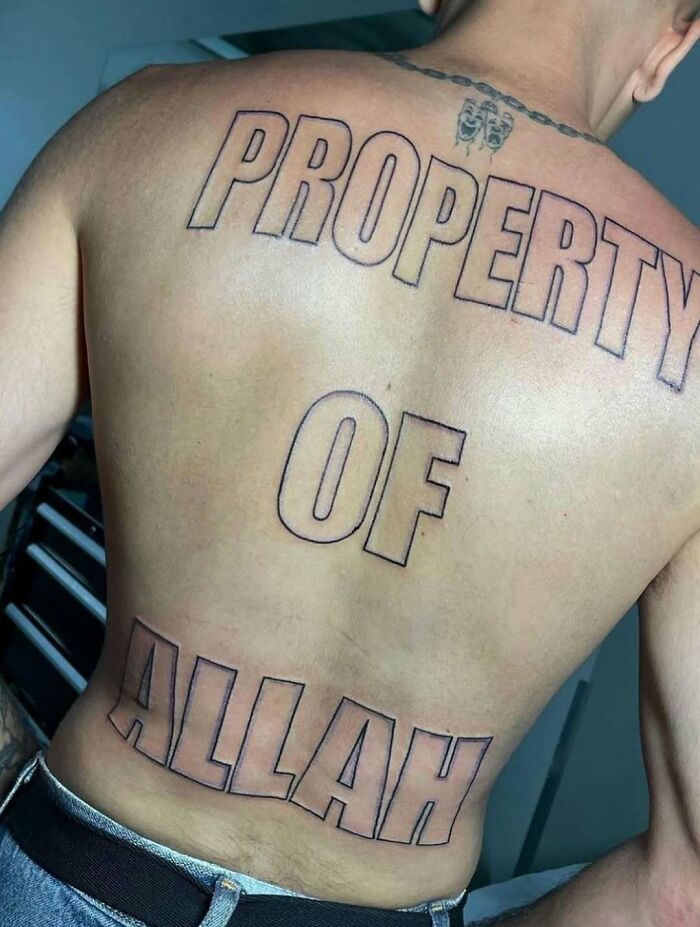 Large outlined tattoo on person's back with the words property of Allah, a cursed photo that makes no sense.