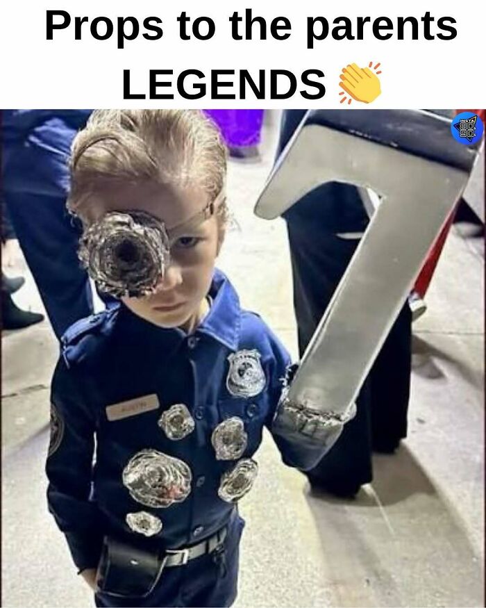 Child dressed as a 90s police officer with fake bullet holes and a number 7 prop, showing 90s life elements no longer exist.