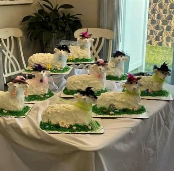 Multiple lamb-shaped cakes with colorful hats arranged on a table, perfect for cursed photos collection.