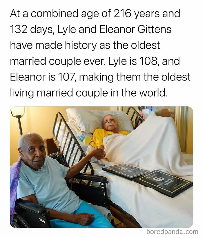 Oldest married couple holding hands in a hospital room with plaques, highlighting surprising facts about longevity.