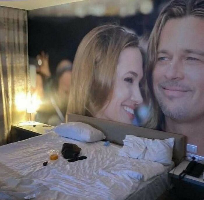 Cursed photo of a bedroom with a bedspread and headboard creating an optical illusion of two faces smiling.