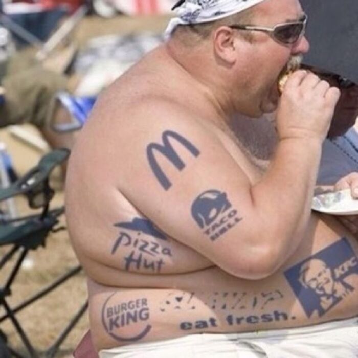 Man with multiple fast food brand tattoos including McDonald's, Taco Bell, Pizza Hut, Burger King, and KFC, showcasing ink fails.