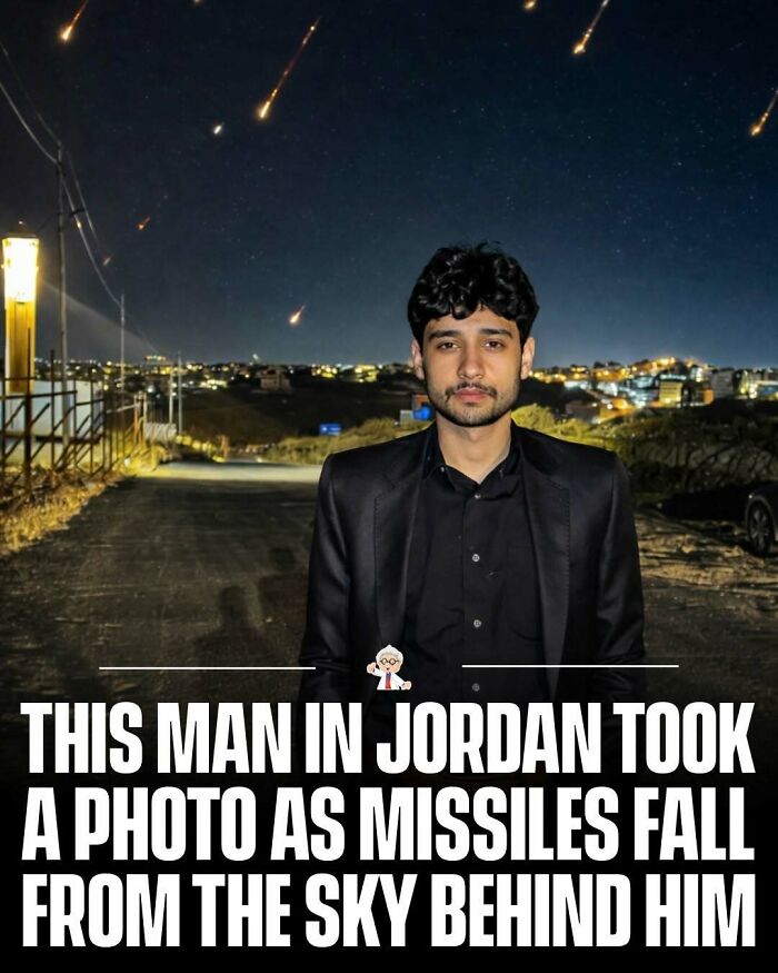 Man in Jordan posing as missiles fall from the sky behind him, a striking and interesting fact captured at night.
