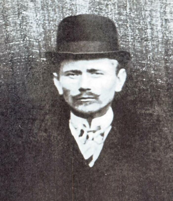 Vintage black and white photo of a man in a suit and hat, representing crazy things people did for love.