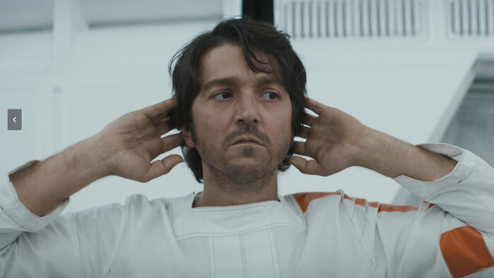 Actor in a white and orange costume with hands behind head, representing Game Of Thrones movie writer casting.