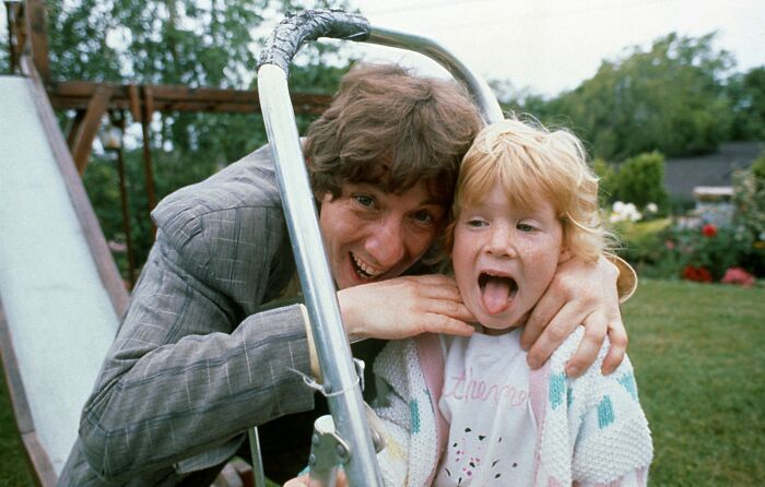 Adult and child playing on a slide in a garden, capturing a moment related to Katherine Short passing cause discussion. Adult and child playing on a slide in a garden, capturing a moment related to Katherine Short passing cause discussion.