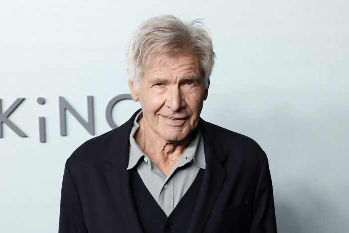 Harrison Ford in a dark jacket and gray shirt at an event, shocking fans with a tearful acting speech. Harrison Ford in a dark jacket and gray shirt at an event, shocking fans with a tearful acting speech.