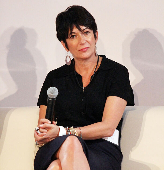 Ghislaine Maxwell sitting on a panel holding a microphone, discussing topics related to Epstein files and politician connections.