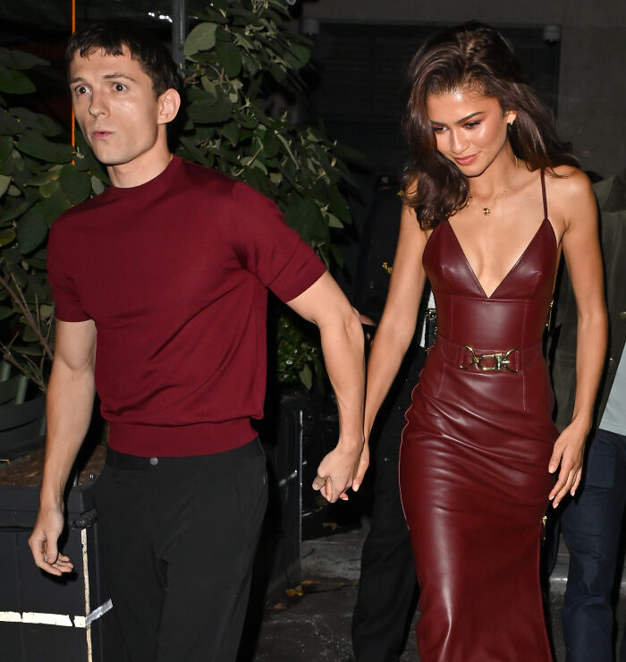 Zendaya and Tom Holland holding hands walking outdoors, breaking silence on marriage rumors with real footage shared.