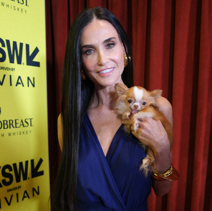 Demi Moore at SXSW event, holding a small dog, sparking concern and backlash over her weight loss.