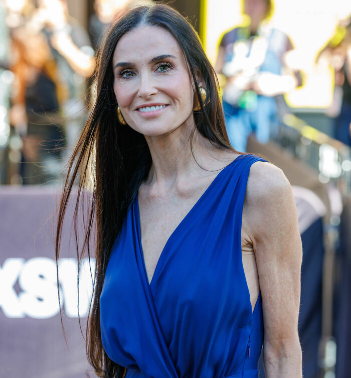 Demi Moore at SXSW, wearing a blue dress, with visible weight loss sparking public concern and backlash.