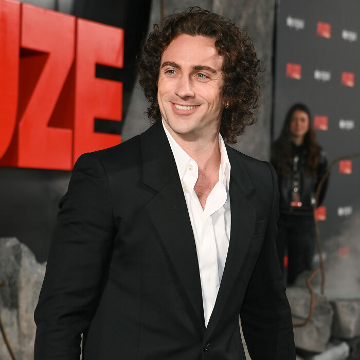 Aaron Taylor-Johnson at a premiere event, wearing a black suit and white shirt, fans notice evolved form of Chalamet changes. Aaron Taylor-Johnson at a premiere event, wearing a black suit and white shirt, fans notice evolved form of Chalamet changes.