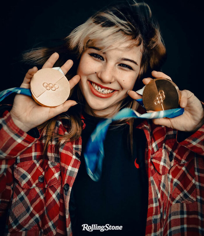 Alysa Liu smiling and holding two Olympic medals, highlighting her skating achievements amid World Championships withdrawal.