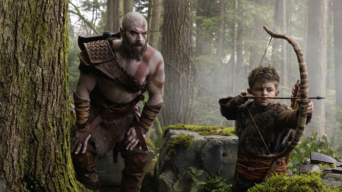 God Of War creator critique Amazon&rsquo;s live-action first look featuring characters in a forest with bow and arrow.