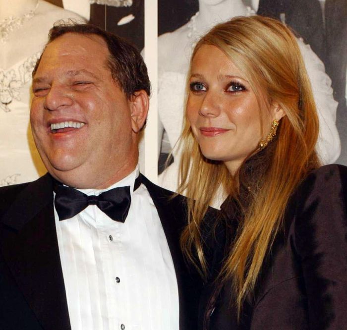 Harvey Weinstein and Gwyneth Paltrow posing together at a formal event, both dressed elegantly.