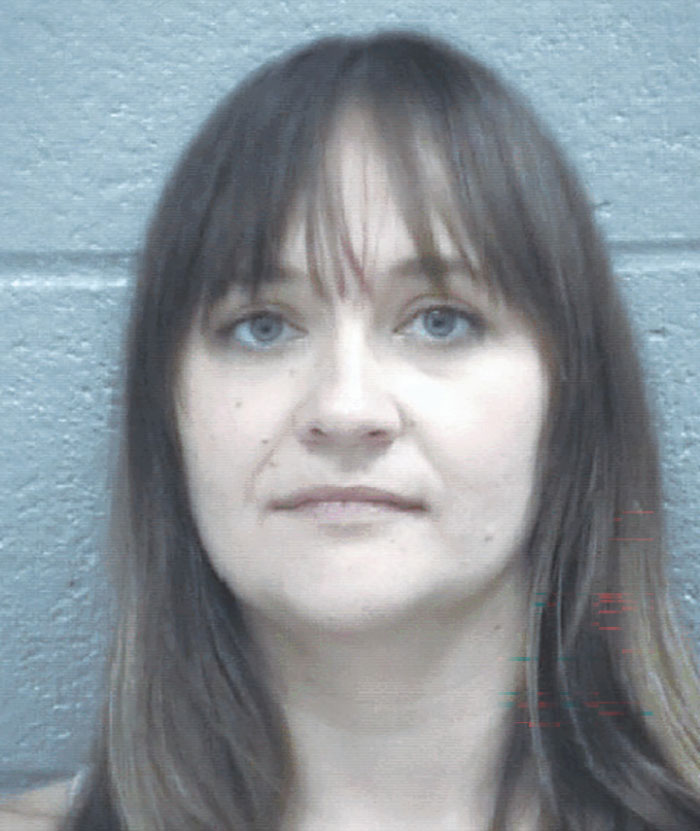 Mugshot of a woman arrested for committing horrible crimes in front of festival crowd with her 5-year-old child nearby.
