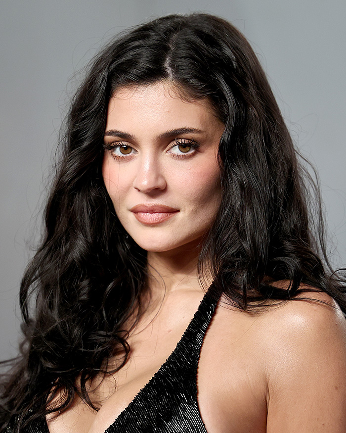 Close-up of a woman with natural skin texture and makeup, showcasing unfiltered stars' skins after Oscars after-party lighting.
