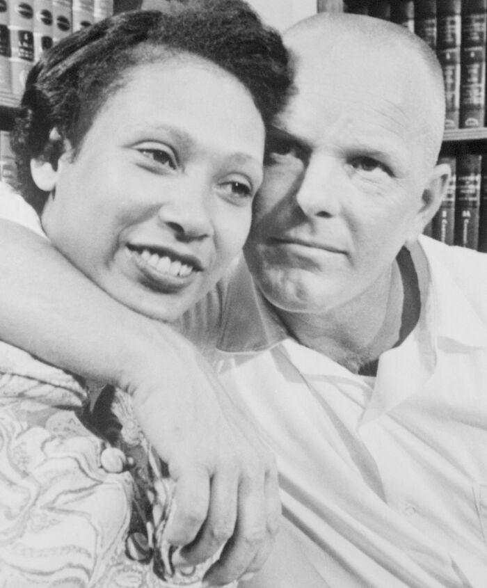 Interracial couple smiling and embracing, showing a powerful example of crazy things people did for love.