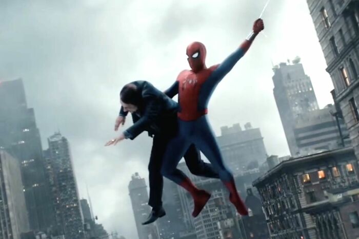 Spider-Man swinging through a city while holding a man, highlighting a controversial change to Tom Holland&rsquo;s web-slinger.