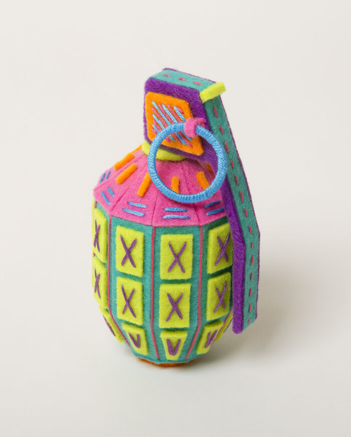 Colorful handcrafted paper g*****e featuring intricate stitched patterns by a French artist duo creating paper worlds.