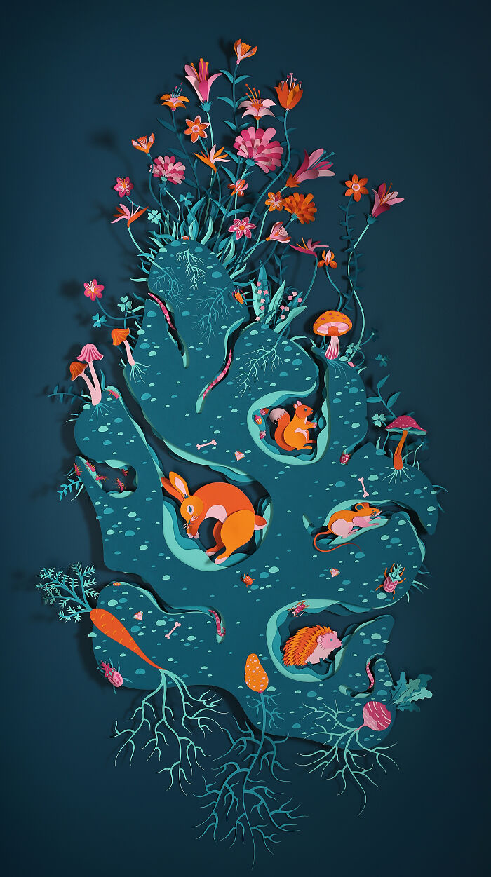 Intricate handcrafted paper art by French artist duo featuring detailed woodland animals and vibrant flowers in layered design.