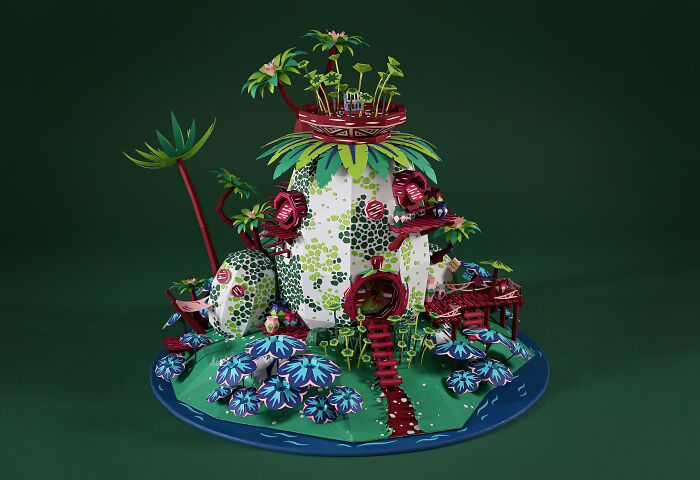 Intricate handcrafted paper model of a whimsical botanical world created by a French artist duo using ordinary paper.
