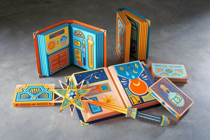 Handcrafted paper art by French artist duo, featuring colorful intricate designs and pop-up elements in a magical theme.