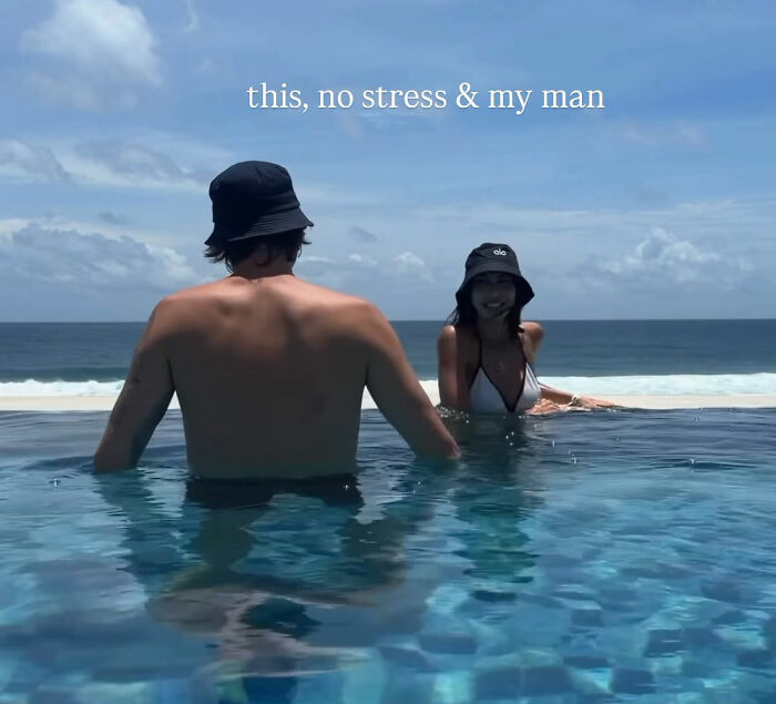 Two people relaxing in an infinity pool overlooking the ocean, unrelated to police release or Bali discovery news.
