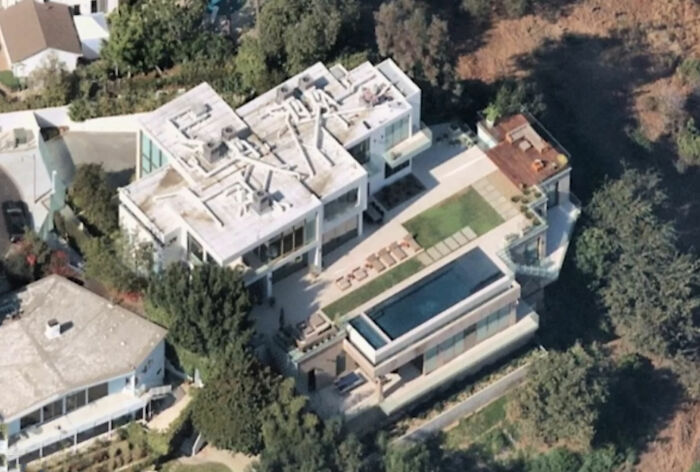 Aerial view of Elon Musk's house exterior showing modern architecture and unique outdoor design details.
