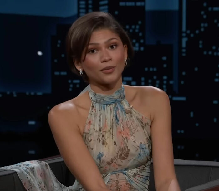 Zendaya speaking in a floral dress during a late-night interview addressing Tom Holland marriage rumors and wedding footage.