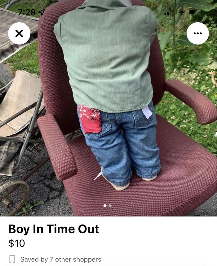 Boy wearing green shirt and jeans sitting facing backward on a red chair in a strange Facebook Marketplace listing.