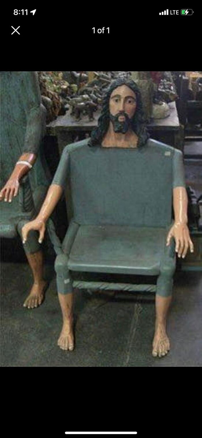 Wooden chair designed with human legs, arms, and a bearded head, an unhinged Facebook Marketplace find.