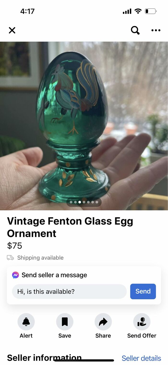 Hand holding vintage Fenton glass egg ornament with rooster design on Facebook Marketplace listing.