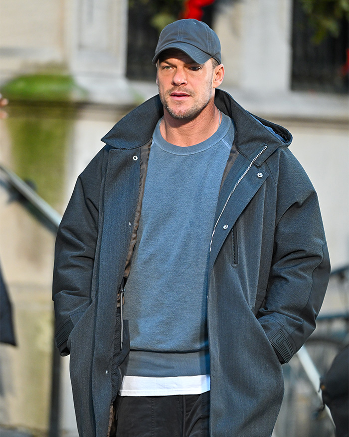 Alan Ritchson wearing a cap and dark coat outdoors, related to bodycam footage of brutal neighbor confrontation.
