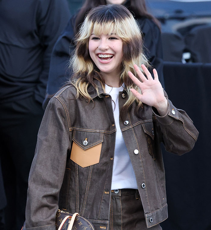 Olympic hero Alysa Liu smiling and waving, revealing why she dropped out of World Championships and fame's price.