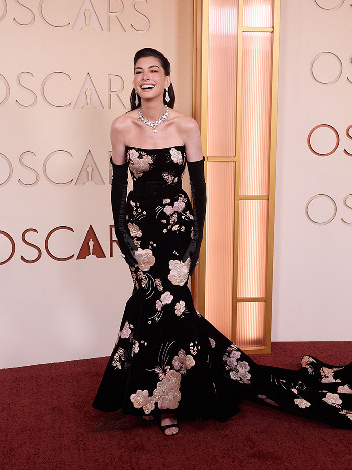 Anne Hathaway wearing floral black gown and jewelry at the Oscars, addressing fans&rsquo; concerns about appearance.