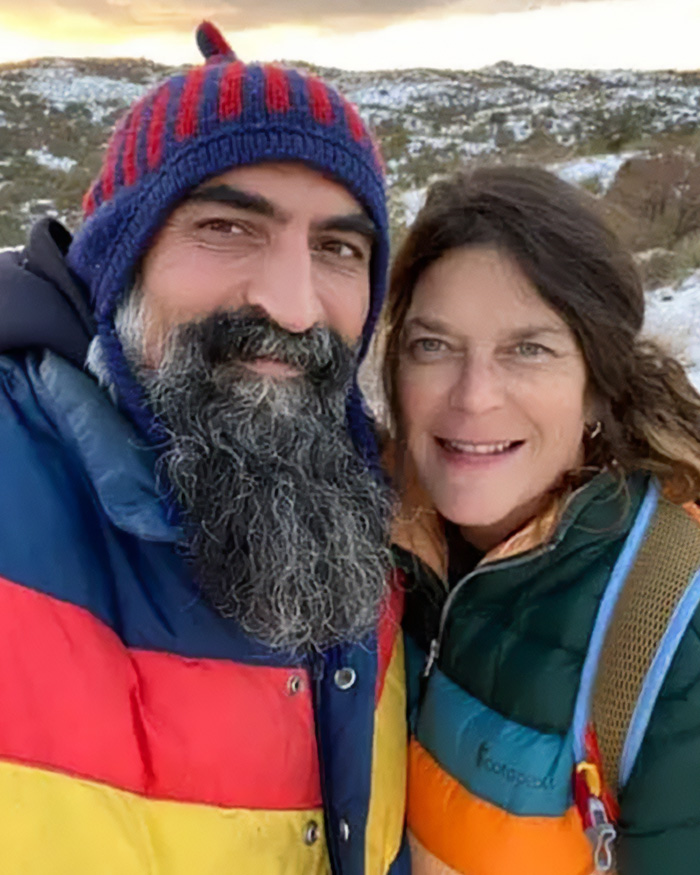 Man with a striped beanie and colorful jacket standing next to a woman outdoors, related to FBI analysis Nancy Guthrie case theories.