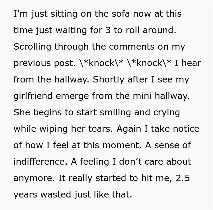 Man sitting on sofa reading comments, girlfriend emerging from hallway emotional after meeting her ex in his apartment.