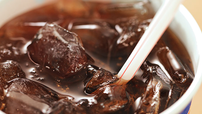 Close-up of a cup filled with iced soda and a white straw, illustrating a common epic PR fail in marketing campaigns.