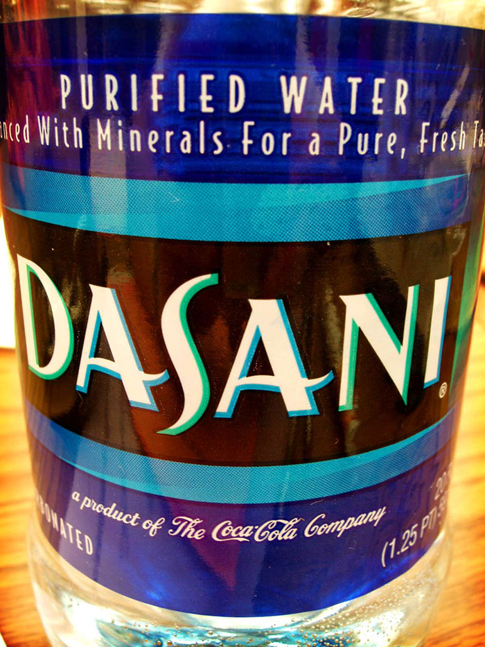 Close-up of a Dasani water bottle label showing branding related to a well-known epic PR fail.