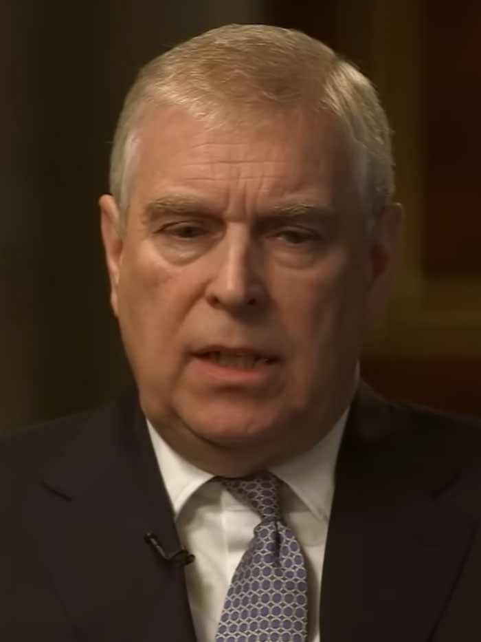 Close-up of a man in a suit and patterned tie speaking during an interview on epic PR fails.