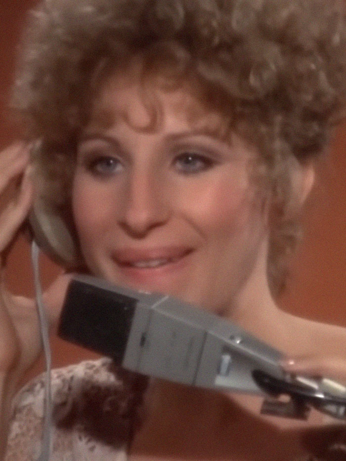Woman with curly hair holding a vintage phone receiver, illustrating an epic PR fail moment from past decades.