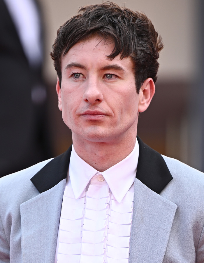 Barry Keoghan in a gray suit and ruffled white shirt at a public event amid acting career reconsideration and fan backlash. Barry Keoghan in a gray suit and ruffled white shirt at a public event amid acting career reconsideration and fan backlash.