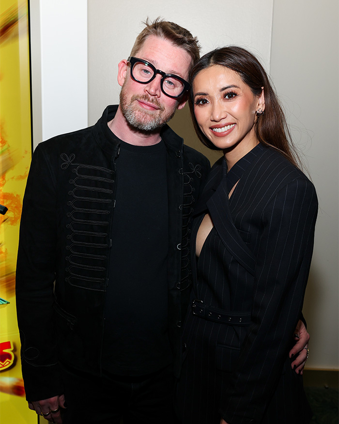 Brenda Song and Macaulay Culkin smiling together at an event, highlighting airline separation issue during flight. Brenda Song and Macaulay Culkin smiling together at an event, highlighting airline separation issue during flight.