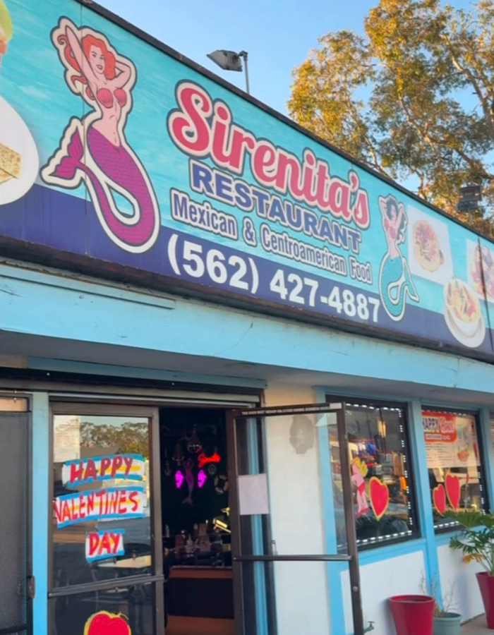 Sirenita's restaurant exterior with colorful signage for Mexican and Centroamerican food and open entrance door.